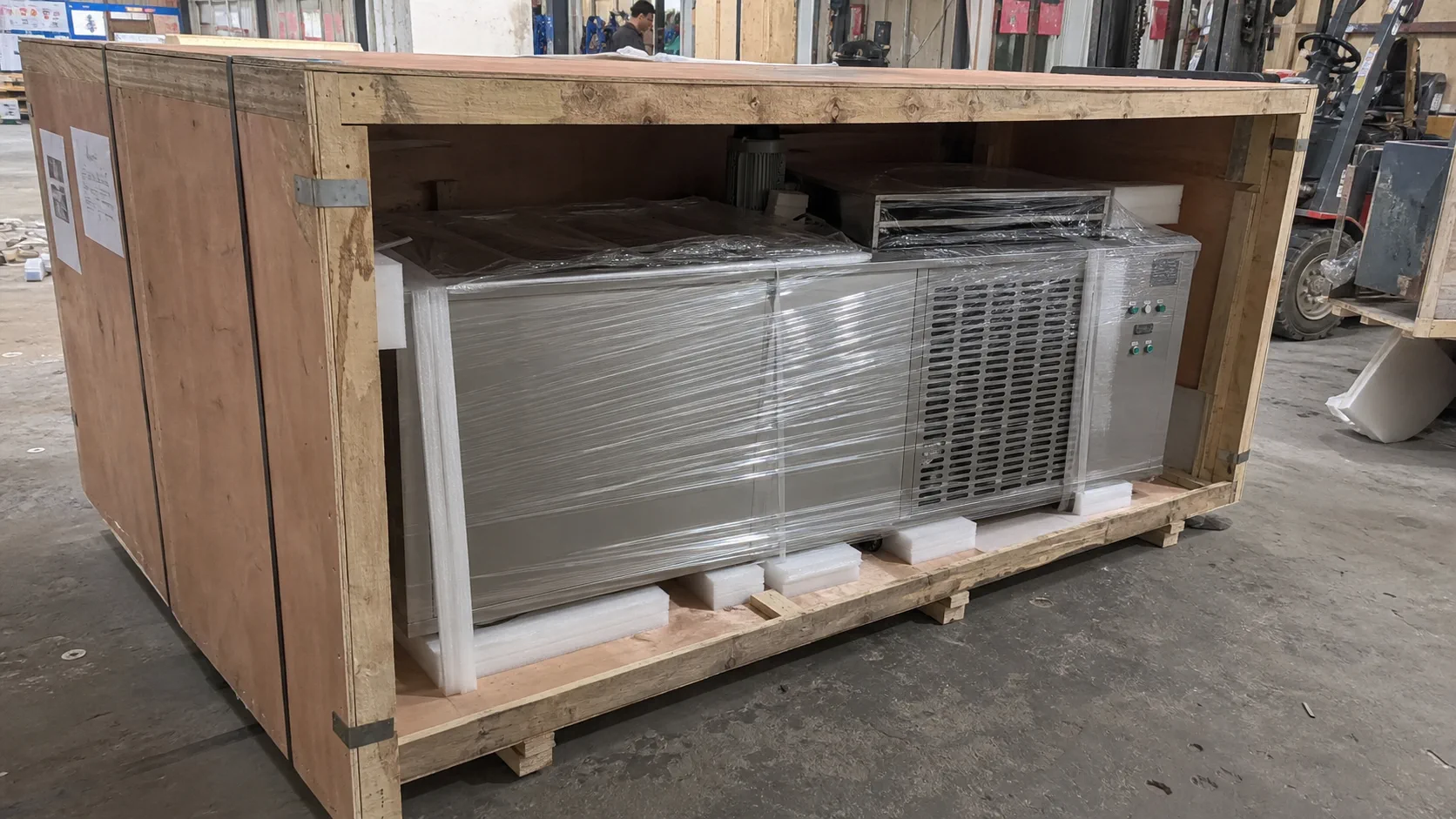 commercial ice machine secured in export wooden crate packaging